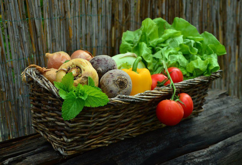 A basket of beetroot parsnips tomatoes peppers and lettuce to support a healthy gut