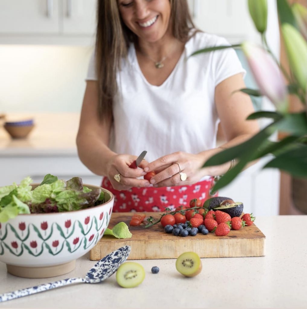 Kara O'Donnell prepping fruit in the kitchen