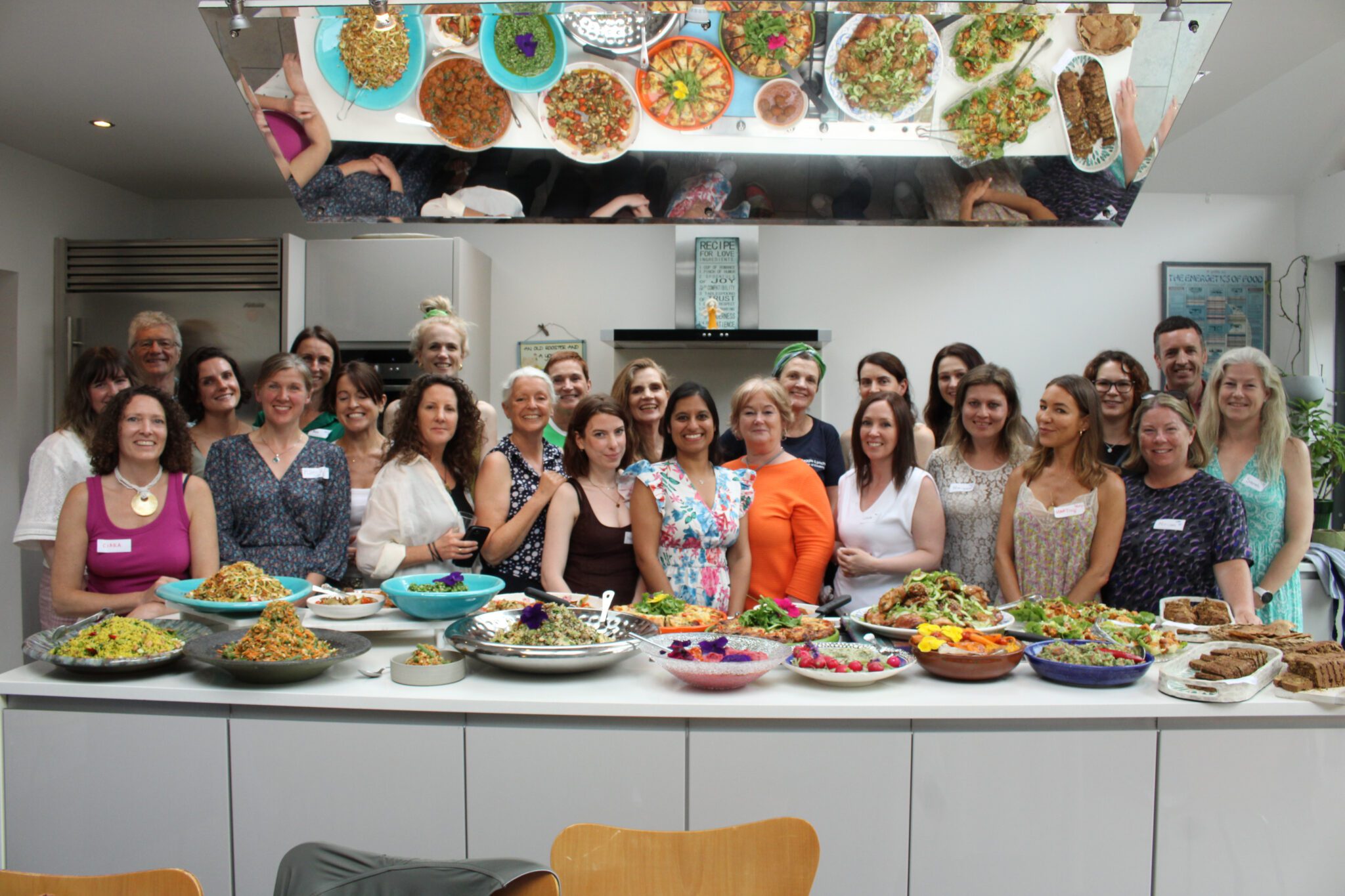 The Class poses for a groupshot at the end of the demonstration, scene the Taste Health kitchen