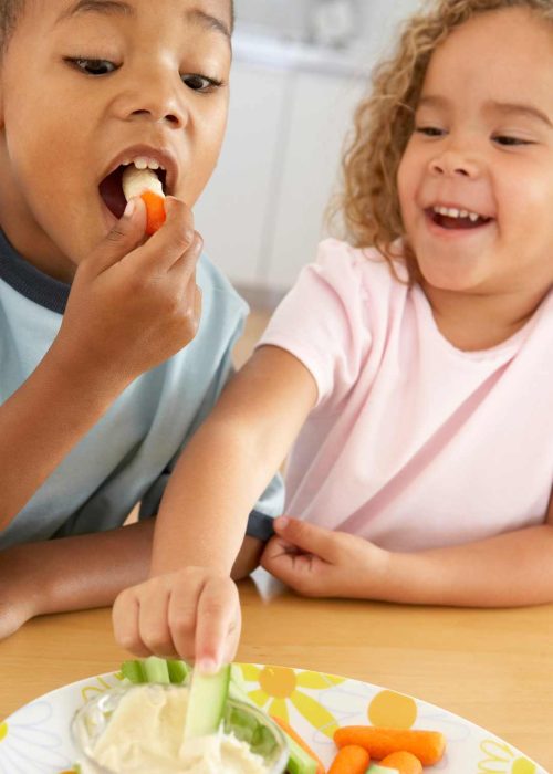 Childhood Nutrition: Kids Enjoying Vegetable Sticks